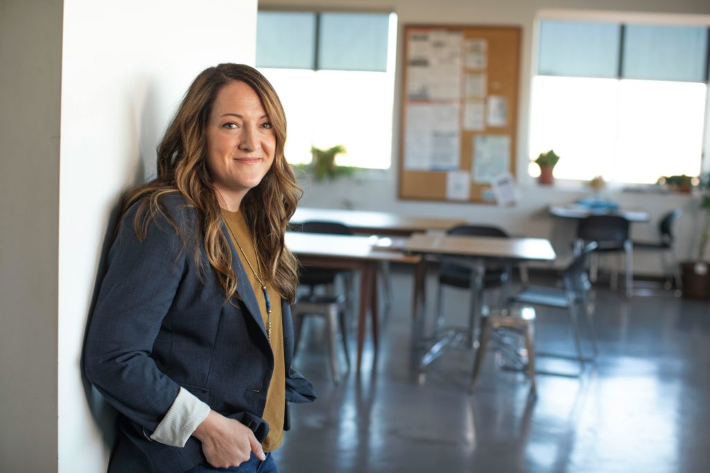 Smiling female employee reflecting positive workplace engagement and satisfaction