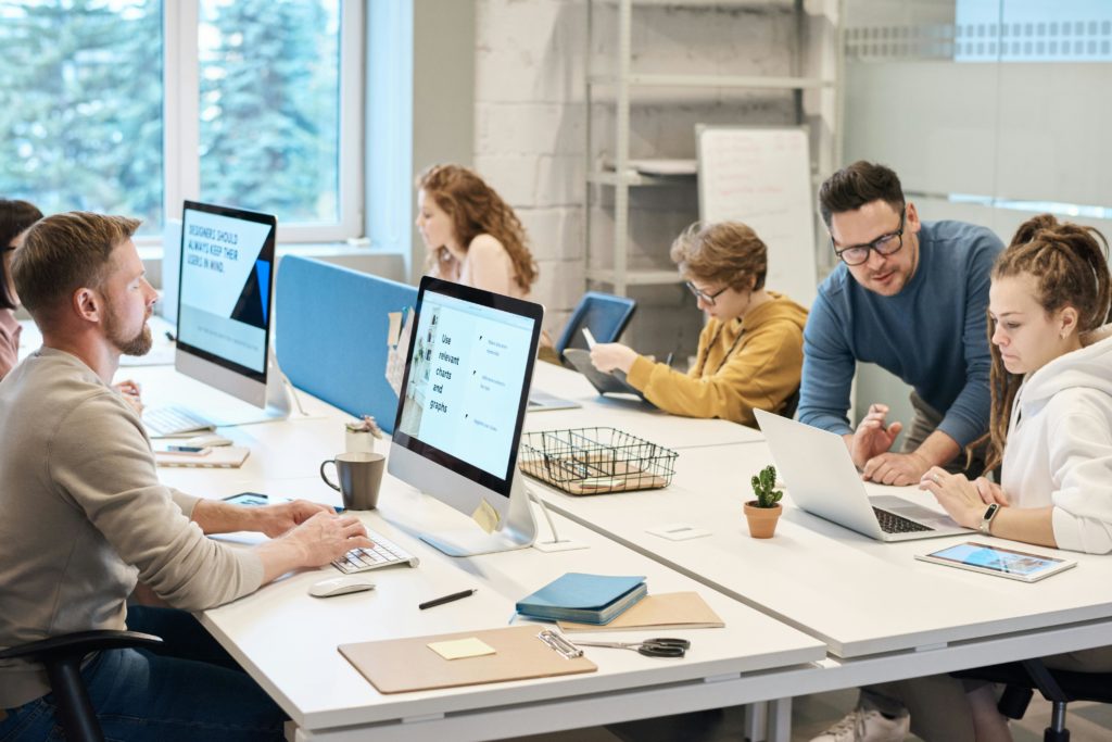 happy, engaged employee at their workstation to highlight the connection between engagement and productivity.